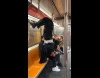 Man hangs upside down on train handle