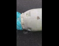 Guy drags friend in white cylinder asphalt