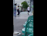 Man in black shorts spandex poses on the wall