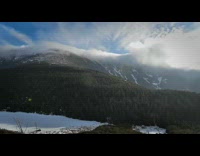 Time lapse clouds roll over the mountain