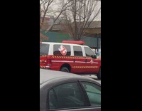 Parked red and white ghostbusters car 
