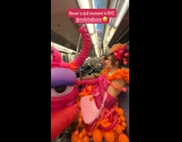 Passenger at subway wearing costume made of balloons 