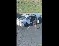 Collab IITW - Woman in black dress dances beside car at the parking lot