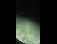 Submitter films moon through telescope airplane passed