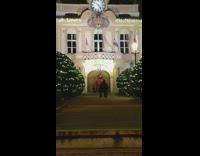 Red jumpsuit lady poses by white house 