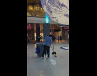 Lady Poses for Photo Reaching for Globe above Her