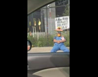 Denim overalls guy sits sidewalk toy baby 