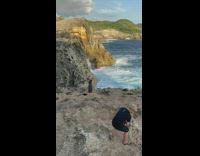 Girl black dress edge of cliff ocean