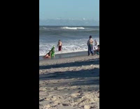 Woman in a shiny Christmas tree costume at the beach