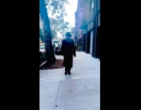 Jew walks on sidewalk and touches grills