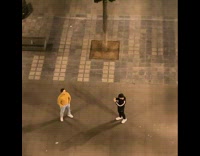 Guy poses at courtyard with feet apart 