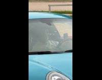 Man talk and films inside sports car