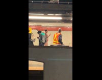 Man in pink g string thong walks around subway station