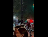 Strange man punches parking machine on street