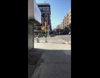 Guy wearing spiderman costume stands on light