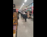 Band marching on store aisle