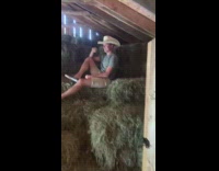 Man sit haystack cowboy hat photo shoot