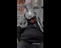 Man wears headdress sleeps on subway ride