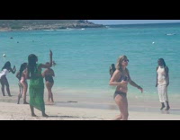 Woman in white beach dress with sunglasses at the beach
