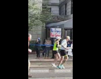 Person with motivational sign Pain is Temporary Pride is Forever marathon