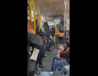 Guy wearing scream movie mask on subway