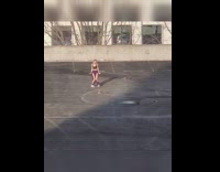 Woman in violet pants tiktok dance rooftop parking lot