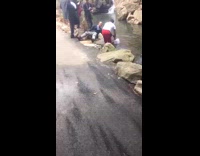 Guy gets baptized park water red shorts 