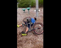 Young boy falls off doing bike tricks