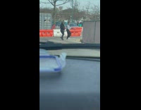 Two women in a hoodie tiktok dance on the street