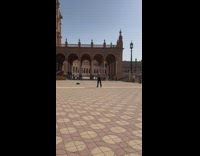 Man in checkered top tiktok dance in the middle of the park