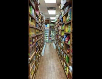 Pigeon walks down aisle in grocery store 