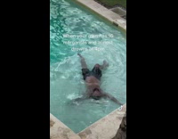 Man in pool laying in shallow end 