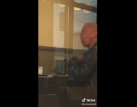 Man in fast food restaurant eating ice cream 