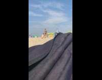 Red white bikini girl sits photographs friend 