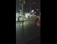 Man takes picture in street cop passes by