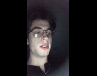 Guy cooking egg that is on fire in black pan 