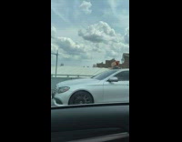 Chucky doll sits on silver car roof