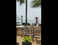 Lady Sweeps Hair Back and Takes Pictures