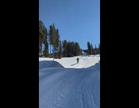 Skier tries to do a spin trick but does not land well