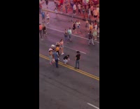 Man in cowboy hat lifts shoes in the street