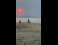 Couple Takes Prenuptial Photos with Drone under Red Sun