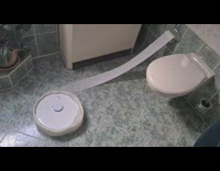 robot vacuum stuck on toilet paper in restroom