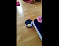 Guy puts note and kick vacuum robot