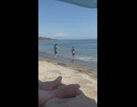Woman in blue bikini poses and run at the beach shore