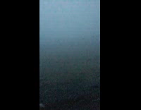 Person walk outside surrounded by thick fog 