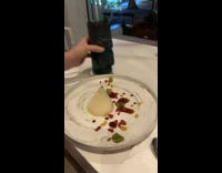 Women shakes vanilla Panna cotta dessert