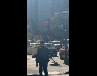 Strange woman climbs at street sign pole