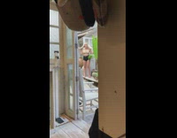 Woman blond hair beige tube top doorway