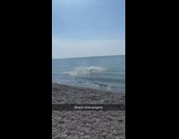 Guy pole vaults in ocean using stick