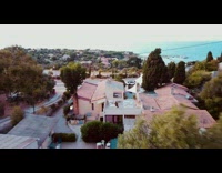 Guy sitting on rooftop flies drone to show view